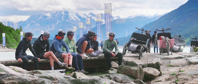 Friends rest together after cycling on there cargobikes through the mountains.